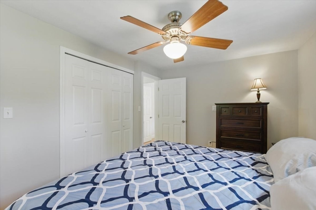 15 Temi Road Beverly, MA 01915 - Photo 30 of 41 a bedroom with a bed and a chandelier