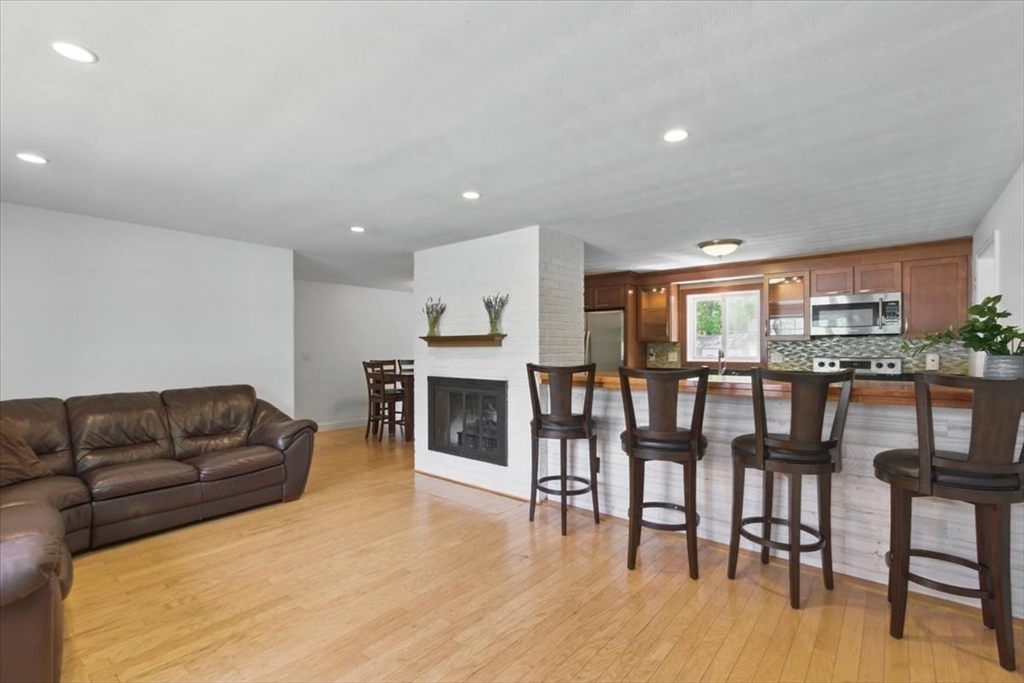 15 Temi Road Beverly, MA 01915 - Photo 7 of 41 a living room with furniture wooden floor and a kitchen view