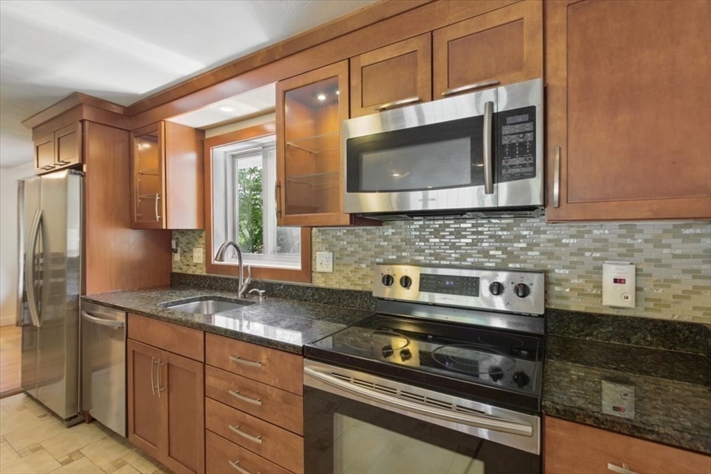 15 Temi Road Beverly, MA 01915 - Photo 10 of 41 a kitchen with stainless steel appliances granite countertop a sink stove and microwave