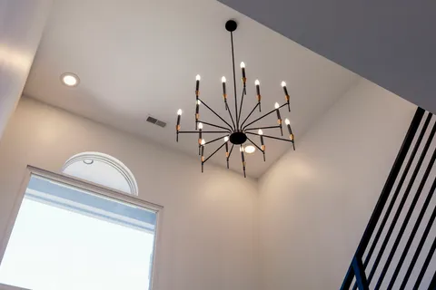 a view of kitchen with furniture and chandelier