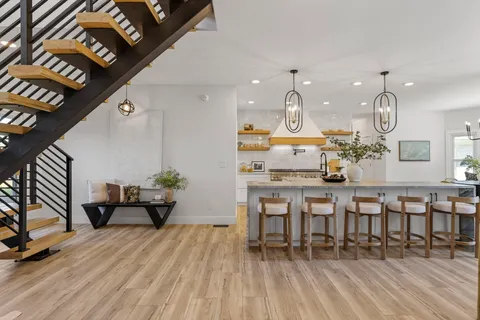 a large kitchen with a table and chairs