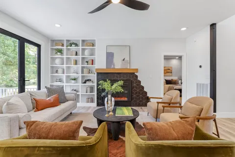 a living room with furniture and a potted plant