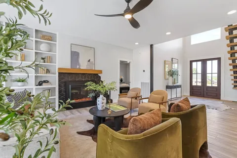 a living room with furniture and a chandelier