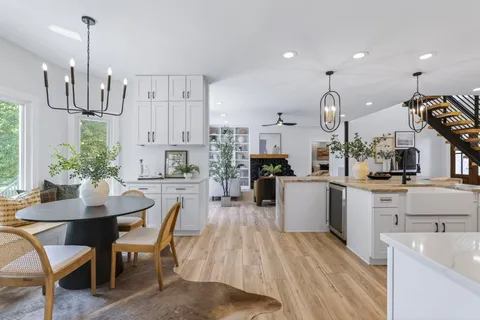 a dining room with furniture and wooden floor