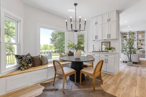 a kitchen with stainless steel appliances granite countertop a stove and a wooden floors