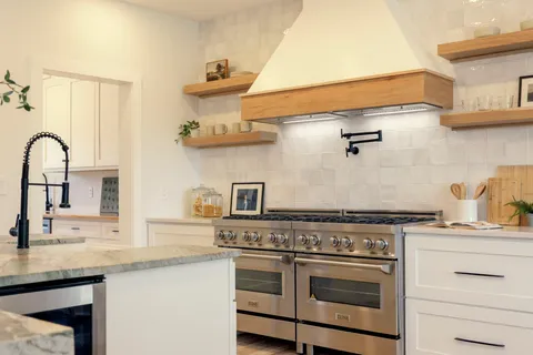 a kitchen with white cabinets and a sink