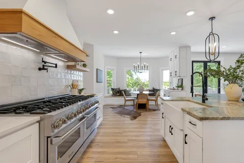 a large kitchen with a stove and cabinets