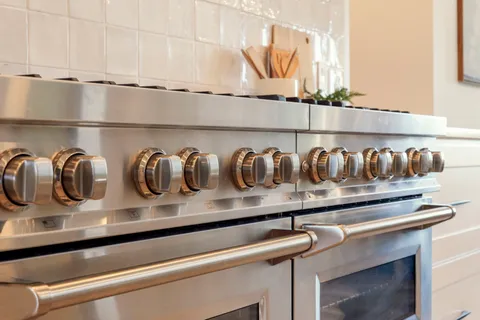 a kitchen with a stove and cabinets
