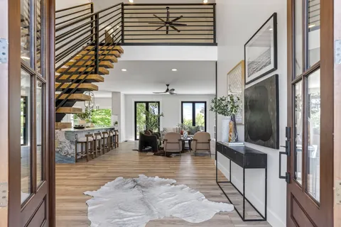 a view of an entryway with wooden floor and front door