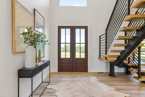 a view of an entryway with wooden floor