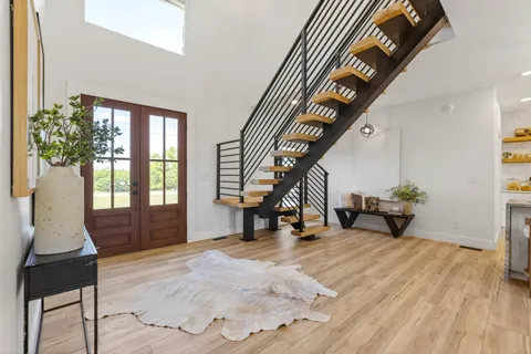a view of entryway and hall with wooden floor