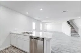 a kitchen with a sink and cabinets