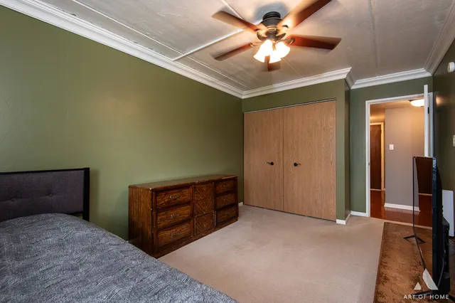 a bedroom with a bed and a chandelier