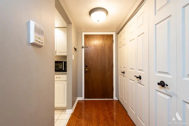 a view of a hallway with wooden floor and staircase