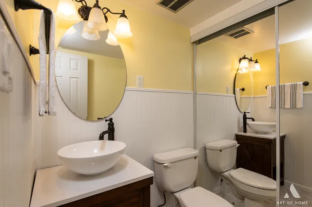 a bathroom with a toilet sink and mirror