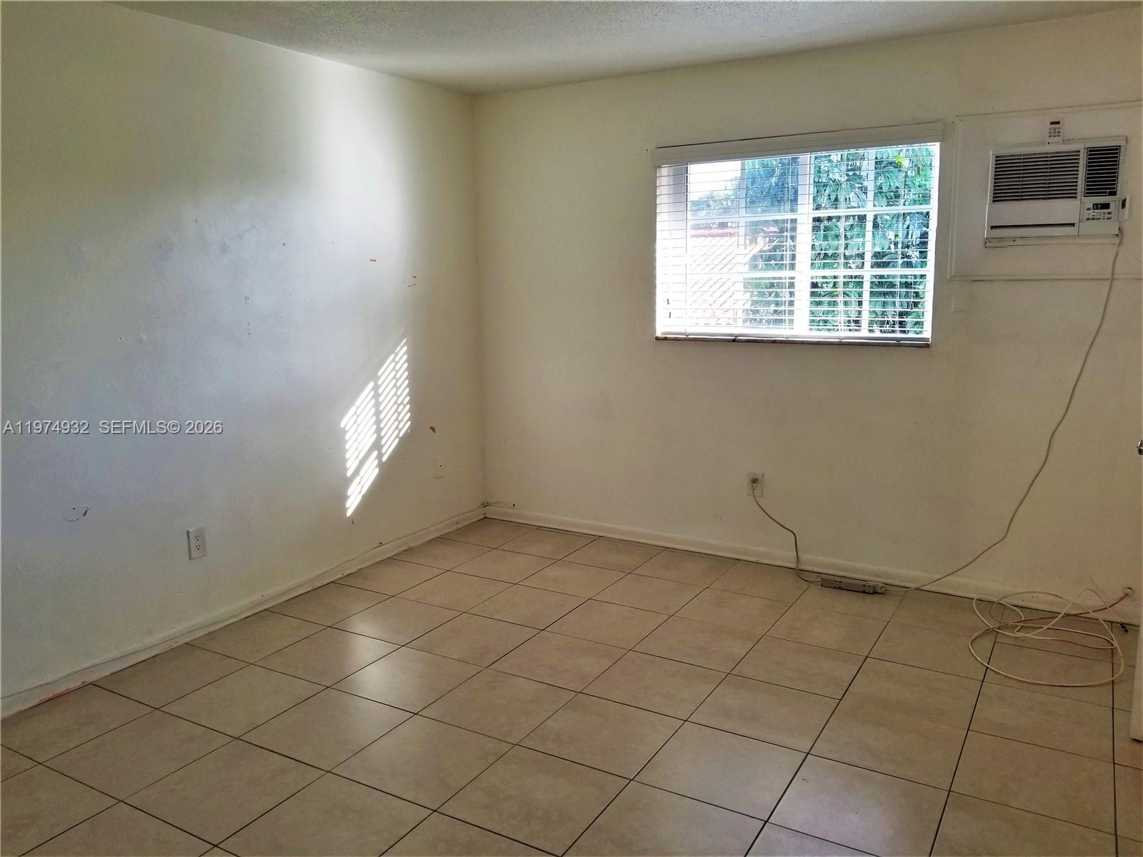 50 West 4th Street, Unit 13 Hialeah, FL 33010 - Photo 5 of 5 an empty room with windows