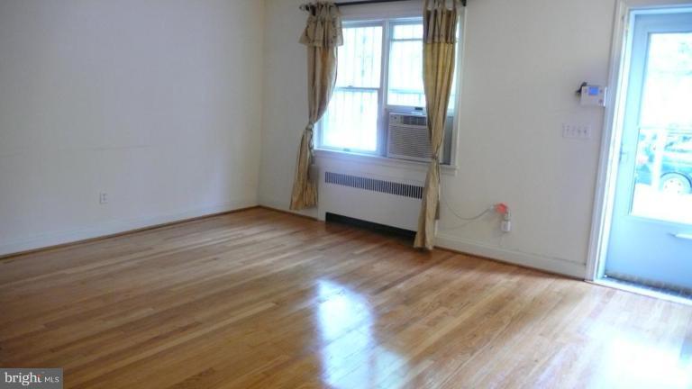 3913 Yolando Road Baltimore, MD 21218 - Photo 3 of 19 an empty room with wooden floor and windows