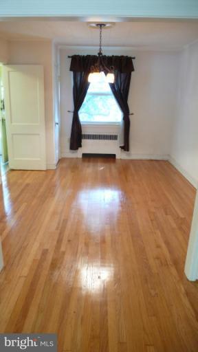 3913 Yolando Road Baltimore, MD 21218 - Photo 4 of 19 a view of empty room with wooden floor and fan