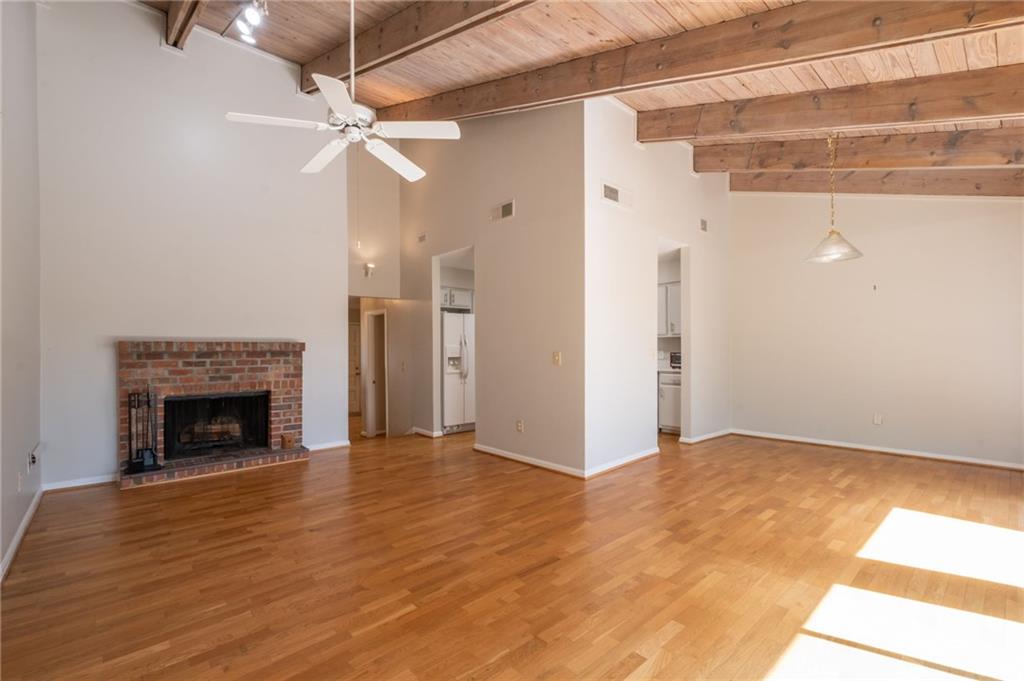 3817 Paces Ferry West Atlanta, GA 30339 - Photo 11 of 34 a view of an empty room with wooden floor fireplace and a window