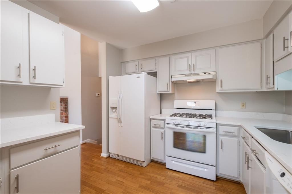 3817 Paces Ferry West Atlanta, GA 30339 - Photo 13 of 34 a kitchen with white cabinets and white appliances