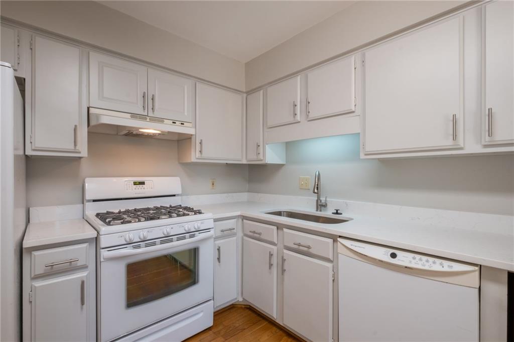 3817 Paces Ferry West Atlanta, GA 30339 - Photo 14 of 34 a kitchen with white cabinets and white appliances