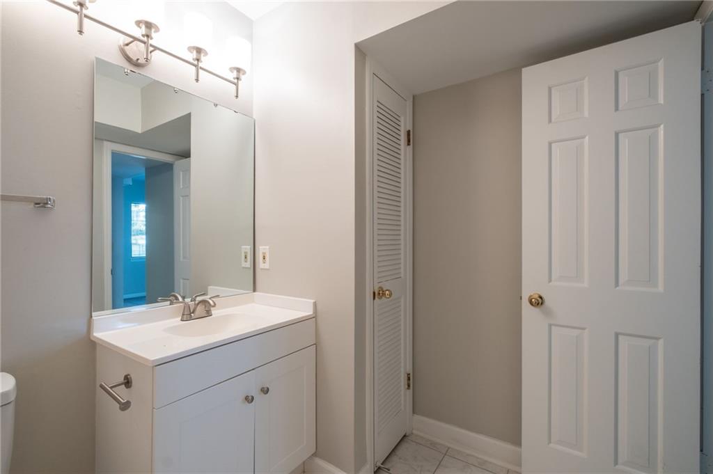 3817 Paces Ferry West Atlanta, GA 30339 - Photo 24 of 34 a bathroom with a sink double vanity and a mirror