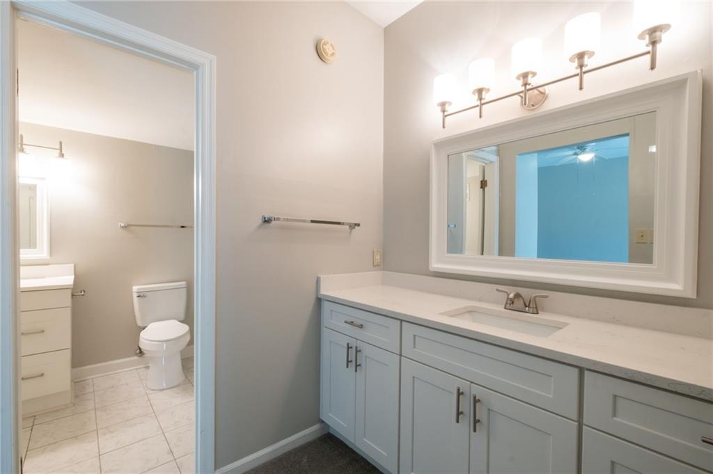 3817 Paces Ferry West Atlanta, GA 30339 - Photo 28 of 34 a bathroom with a sink a toilet and a mirror