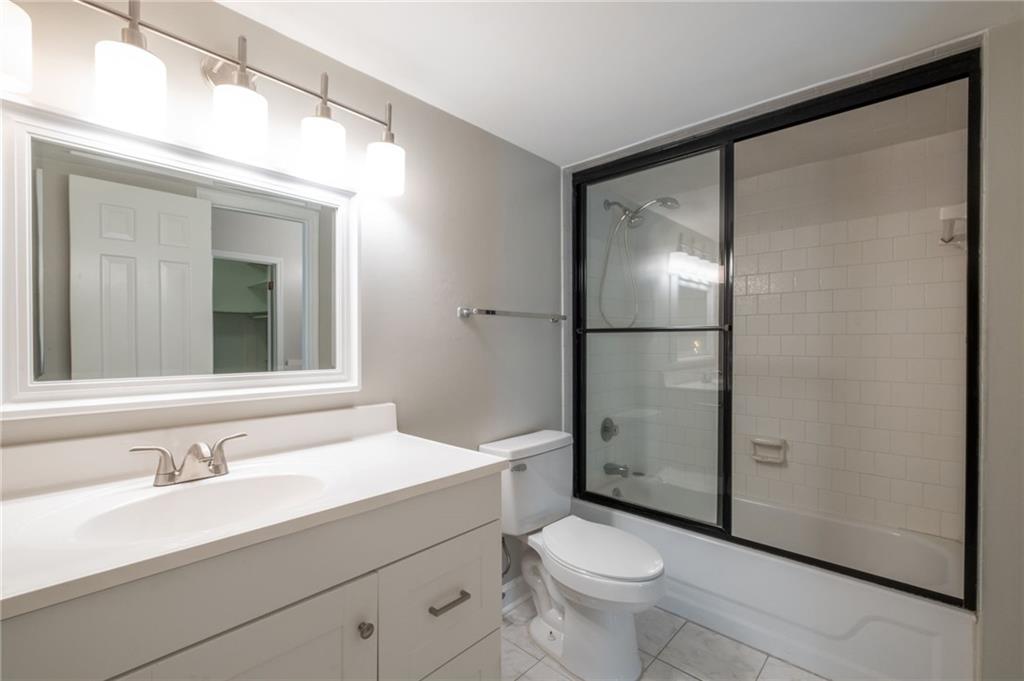 3817 Paces Ferry West Atlanta, GA 30339 - Photo 30 of 34 a bathroom with a granite countertop sink toilet and shower