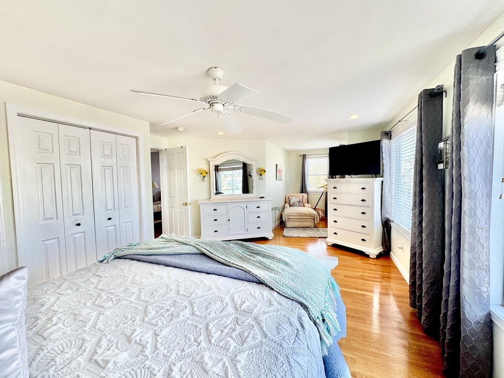 181 Atlantic Avenue Hull, MA 02045 - Photo 15 of 42 a bedroom with a bed and wooden floor