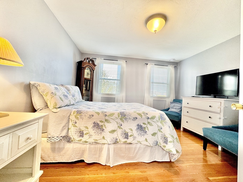 181 Atlantic Avenue Hull, MA 02045 - Photo 17 of 42 a bedroom with a bed and flat tv screen on the dresser