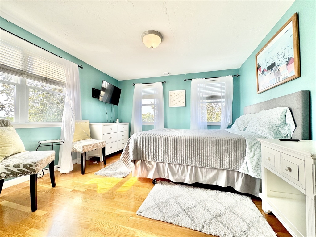 181 Atlantic Avenue Hull, MA 02045 - Photo 18 of 42 a bedroom with a bed and wooden floor