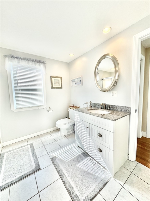 181 Atlantic Avenue Hull, MA 02045 - Photo 23 of 42 a bathroom with a sink mirror vanity and a toilet