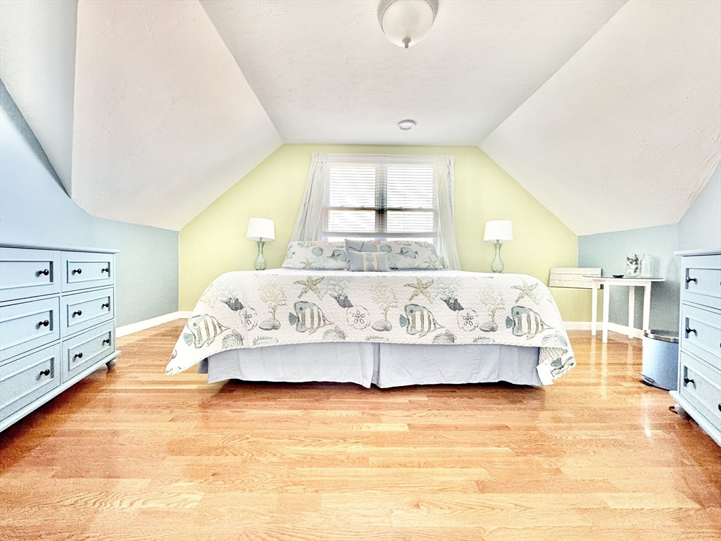 181 Atlantic Avenue Hull, MA 02045 - Photo 27 of 42 a spacious bedroom with a large bed and a window