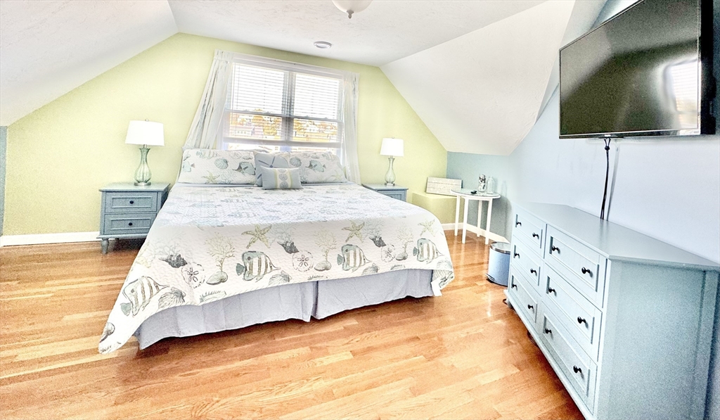 181 Atlantic Avenue Hull, MA 02045 - Photo 29 of 42 a spacious bedroom with a bed and flat screen tv