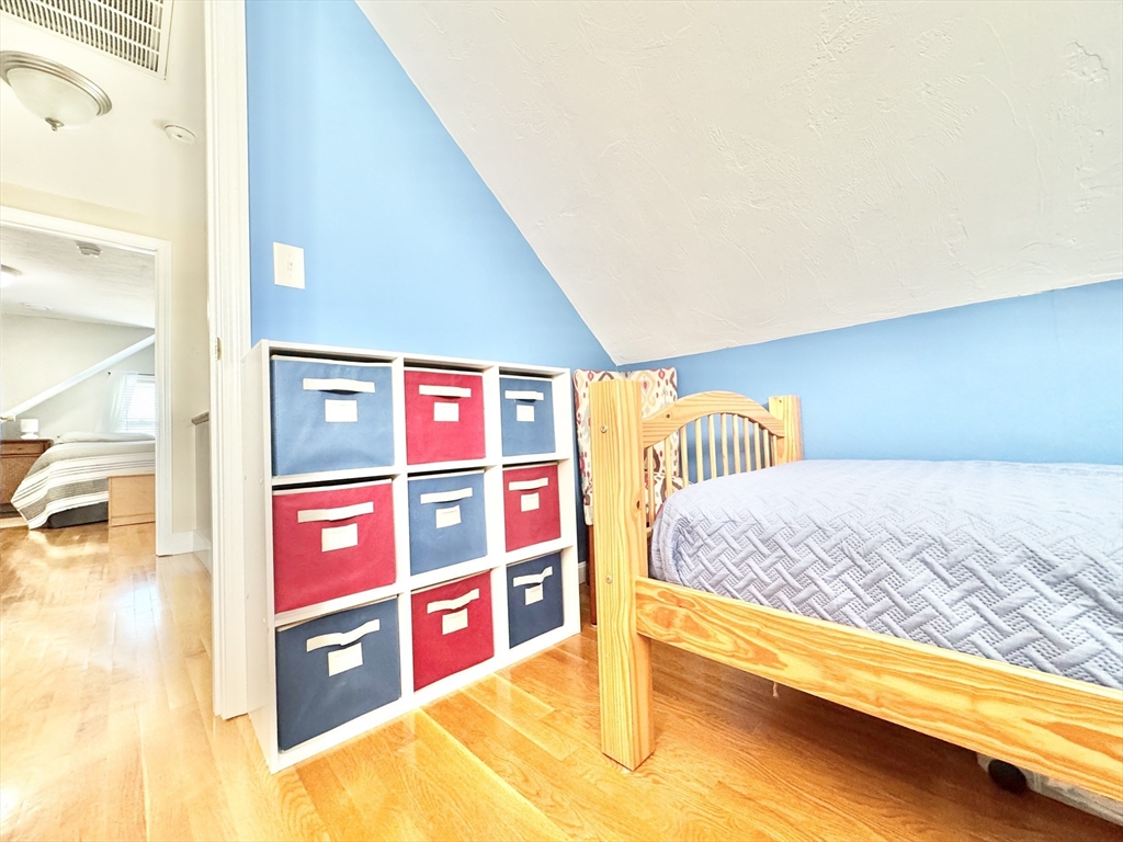 181 Atlantic Avenue Hull, MA 02045 - Photo 32 of 42 a bedroom with bed and a night stand