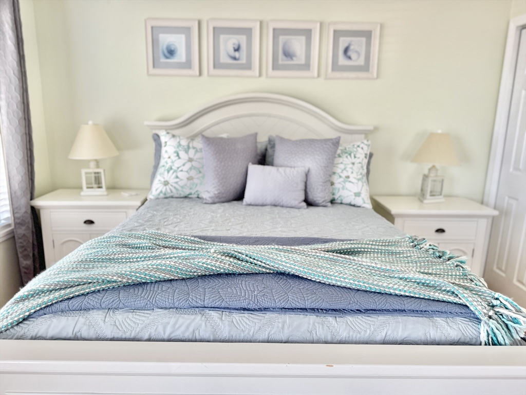 181 Atlantic Avenue Hull, MA 02045 - Photo 34 of 42 a bedroom with a bed and a window