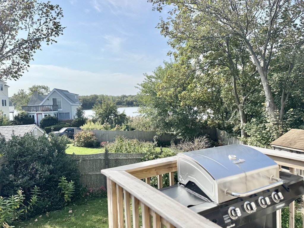 181 Atlantic Avenue Hull, MA 02045 - Photo 4 of 42 a view of a patio with table and chairs and potted plants