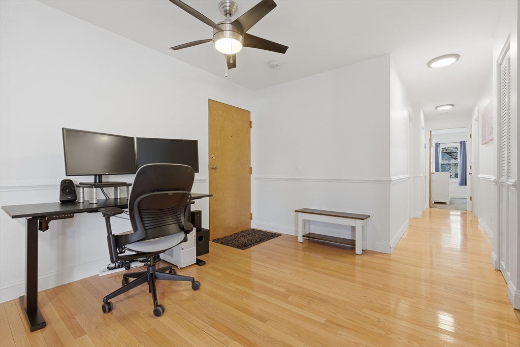 281 West 2nd Street, Unit A1 Boston, MA 02127 - Photo 5 of 17 a view of a workspace with furniture and wooden floor