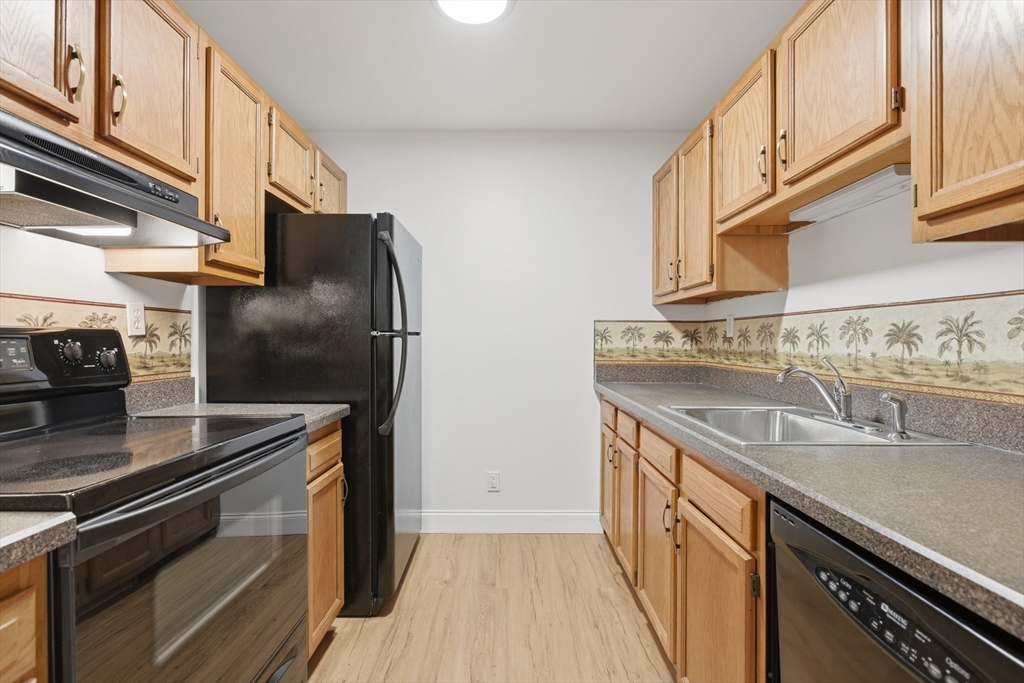 281 West 2nd Street, Unit A1 Boston, MA 02127 - Photo 6 of 17 a kitchen with stainless steel appliances granite countertop a sink and a refrigerator