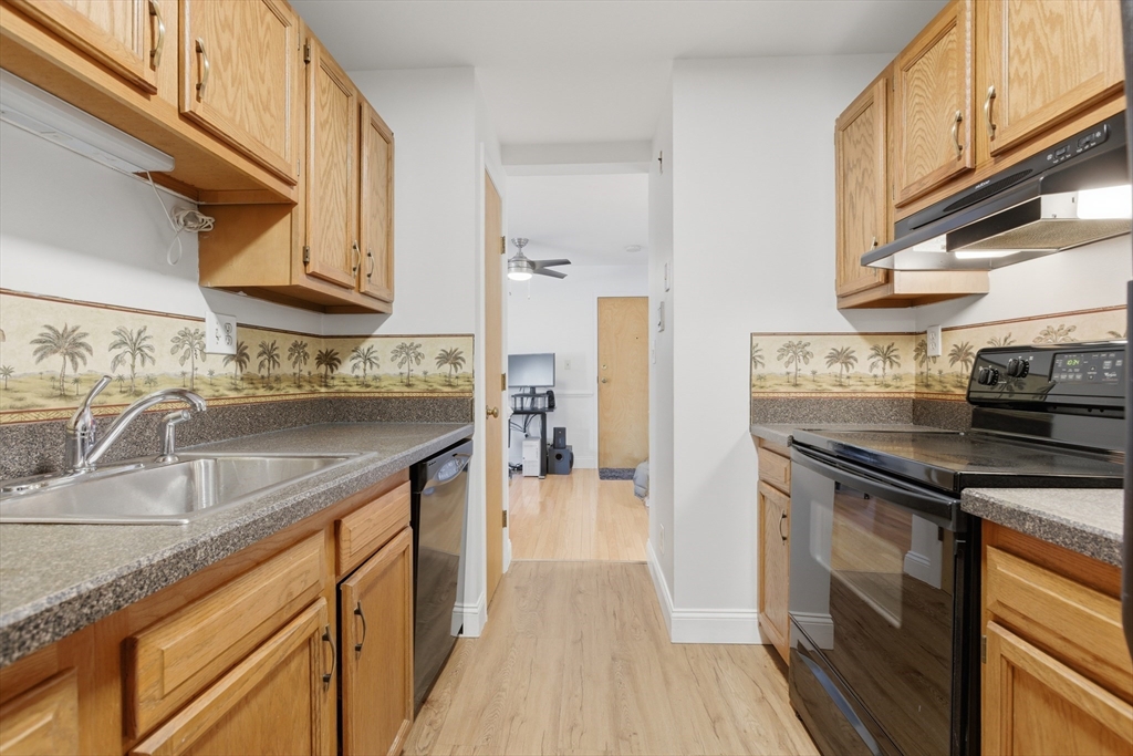 281 West 2nd Street, Unit A1 Boston, MA 02127 - Photo 7 of 17 a kitchen with stainless steel appliances granite countertop a sink stove and refrigerator