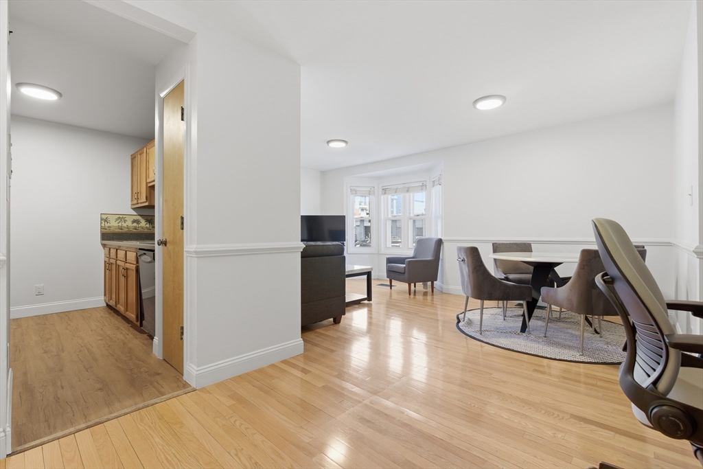 281 West 2nd Street, Unit A1 Boston, MA 02127 - Photo 8 of 17 a view of a dining room with furniture a rug and wooden floor