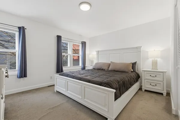 a spacious bedroom with a bed and window