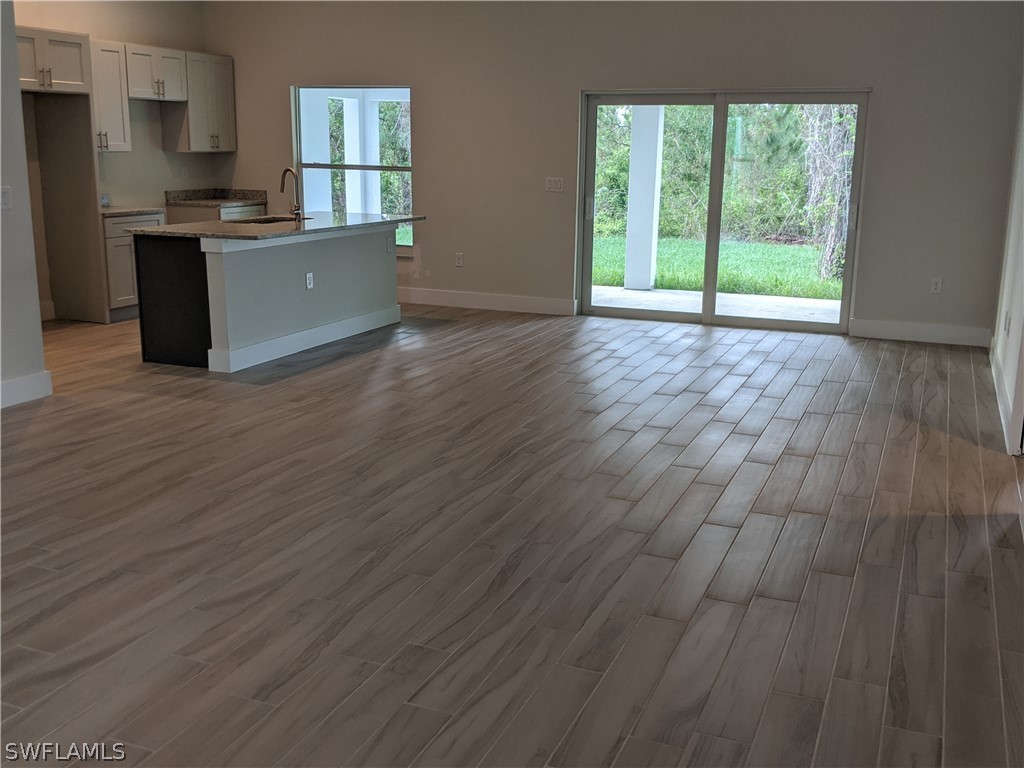 2930 18th Street Southwest Lehigh Acres, FL 33976 - Photo 20 of 20 a view of a kitchen with wooden floor and electronic appliances
