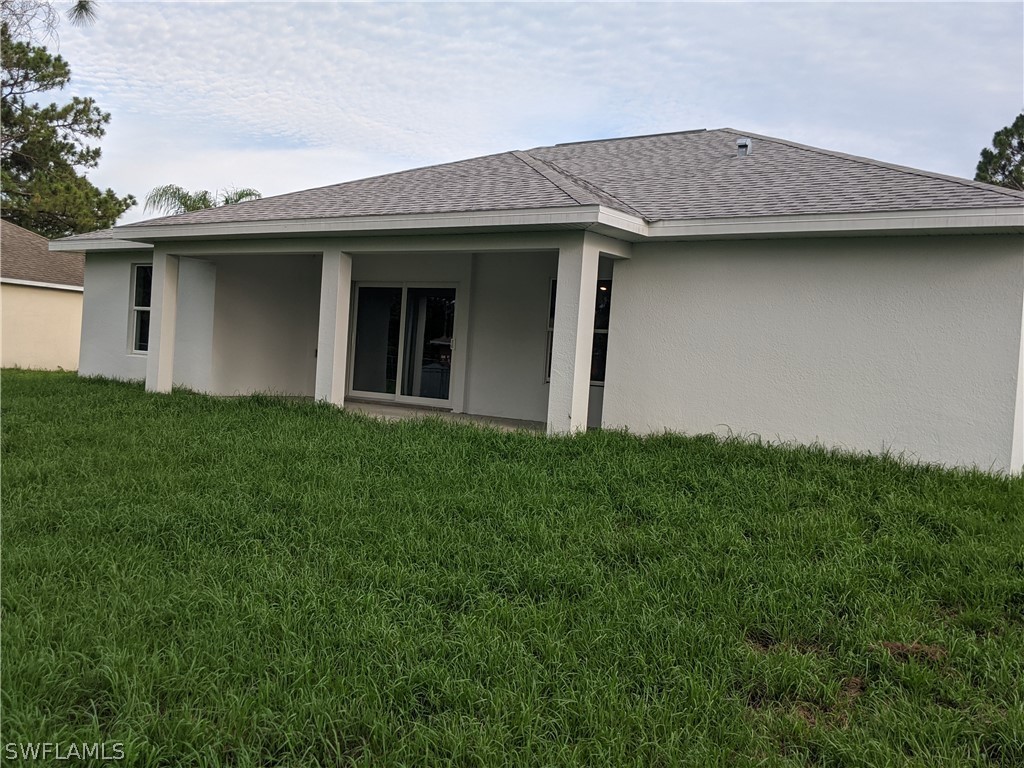 2930 18th Street Southwest Lehigh Acres, FL 33976 - Photo 2 of 20 a view of a house with a garden