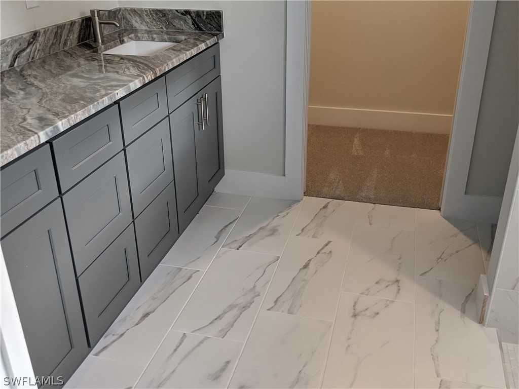 2930 18th Street Southwest Lehigh Acres, FL 33976 - Photo 6 of 20 a kitchen with a sink and cabinets