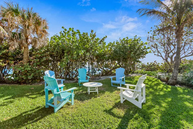 a wooden bench sitting in the middle of a garden
