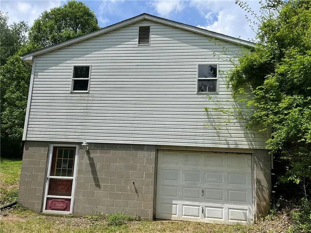 a front view of a house with plants