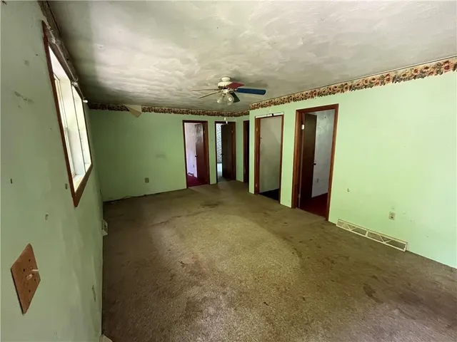 a view of a livingroom with an empty space and a window