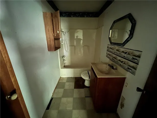 a bathroom with a sink a toilet and a mirror