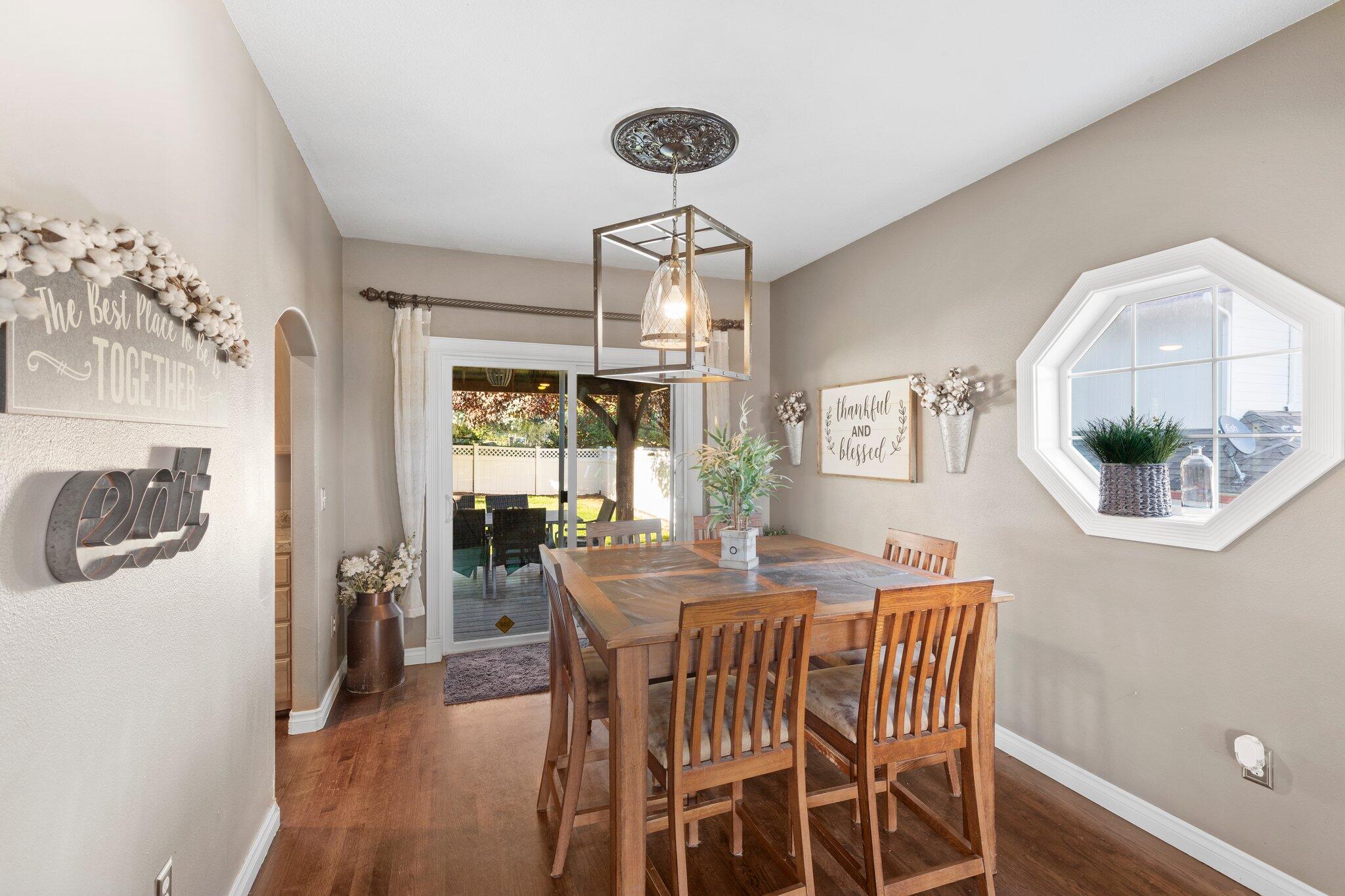 878 Ridgeview Drive Eagle Point, OR 97524 - Photo 9 of 39 a view of a dining room with furniture wooden floor and chandelier